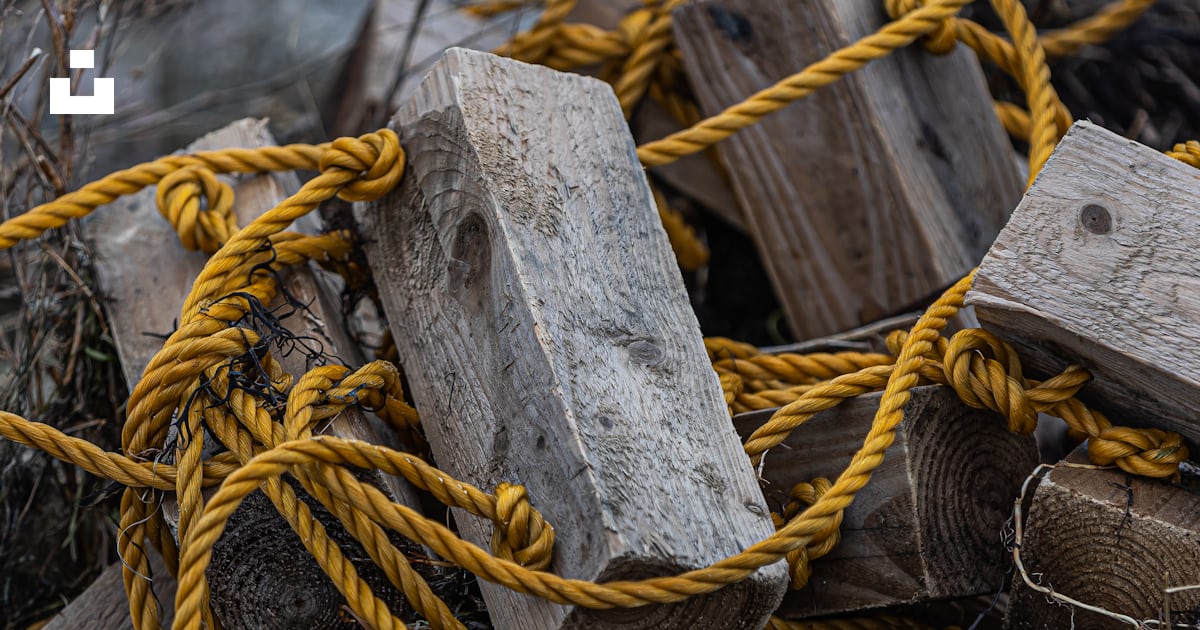 A pile of wood blocks and ropes on a rocky hillside photo – Free ...
