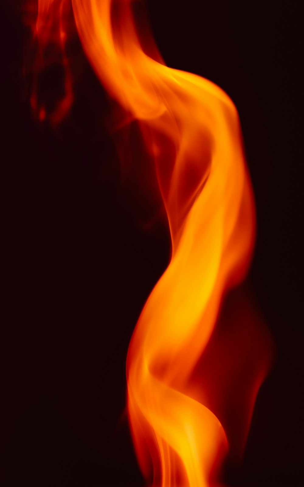 a blurry photo of fire on a black background