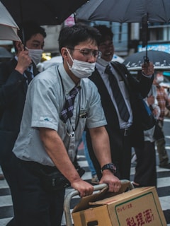 Employees wearing custom-made uniforms and holding umbrellas with company branding