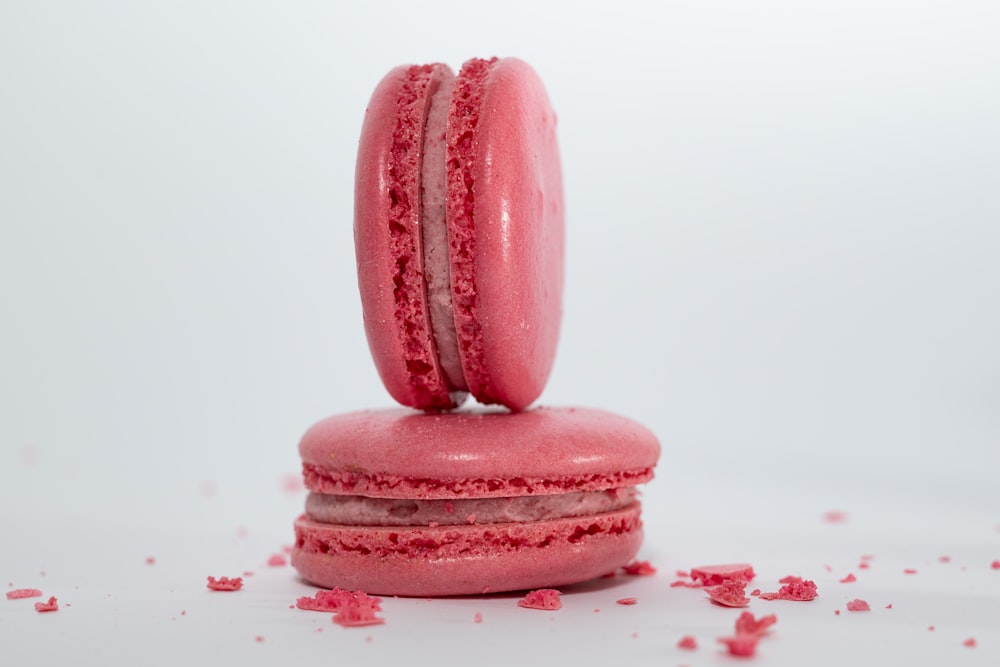 a couple of pink macaroons sitting on top of each other