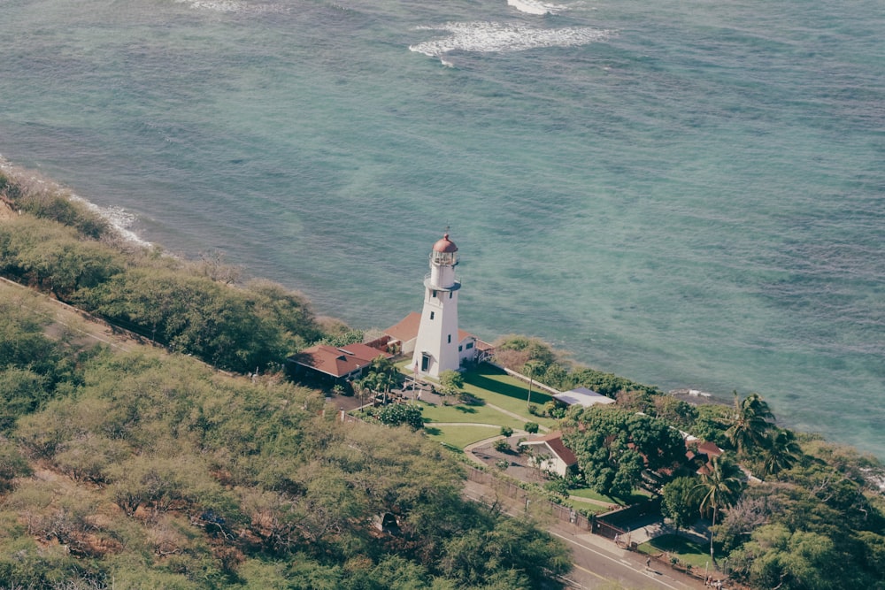 an aerial view of a lighthouse near the ocean