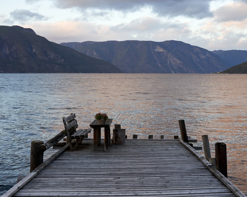 a wooden dock with two benches on it