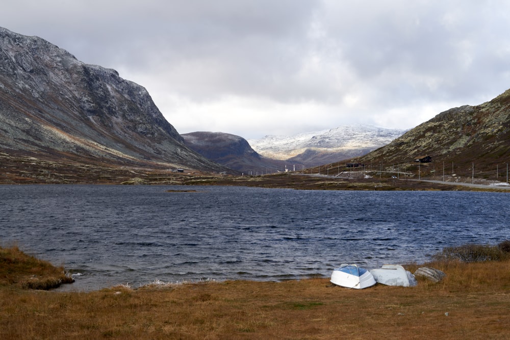 a body of water with mountains in the background