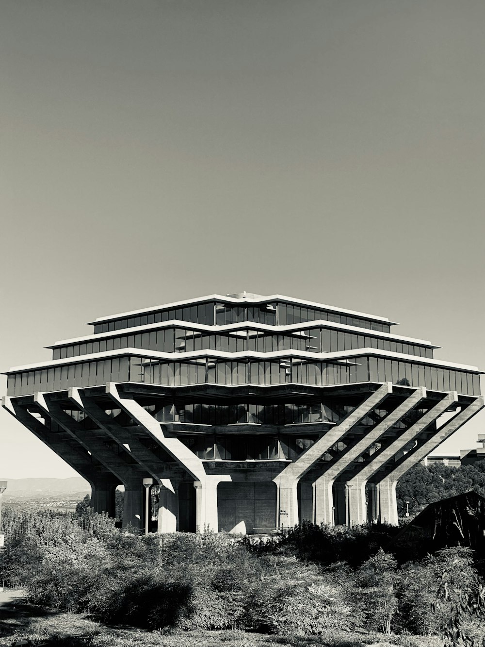 a very tall building sitting in the middle of a field