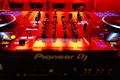 a dj's deck with a red light behind it