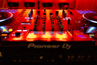 a dj's deck with a red light behind it