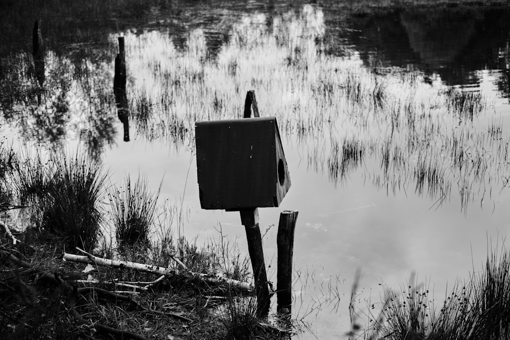 a black and white photo of a box in the water