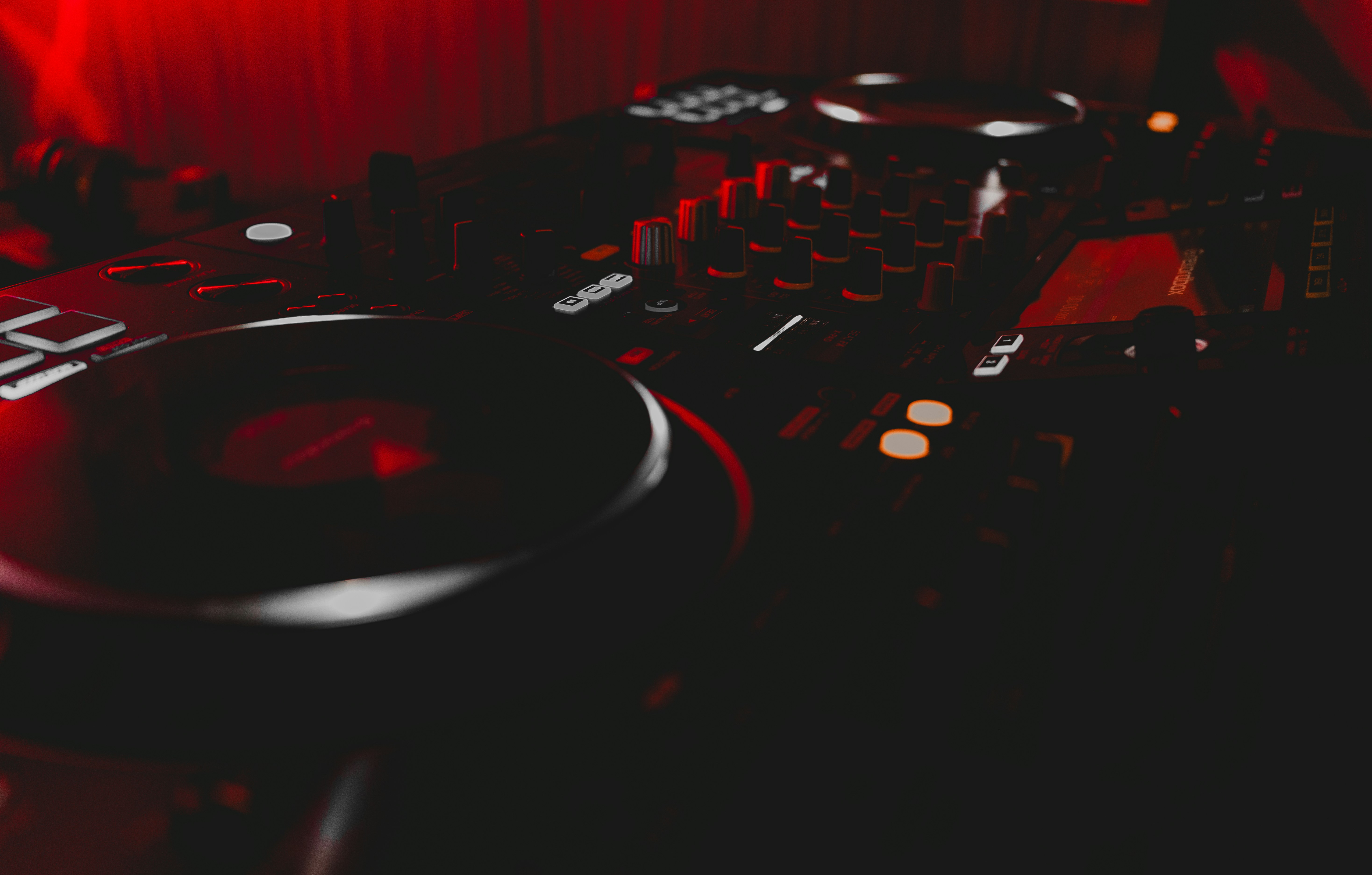 a dj mixing equipment in a dark room, 