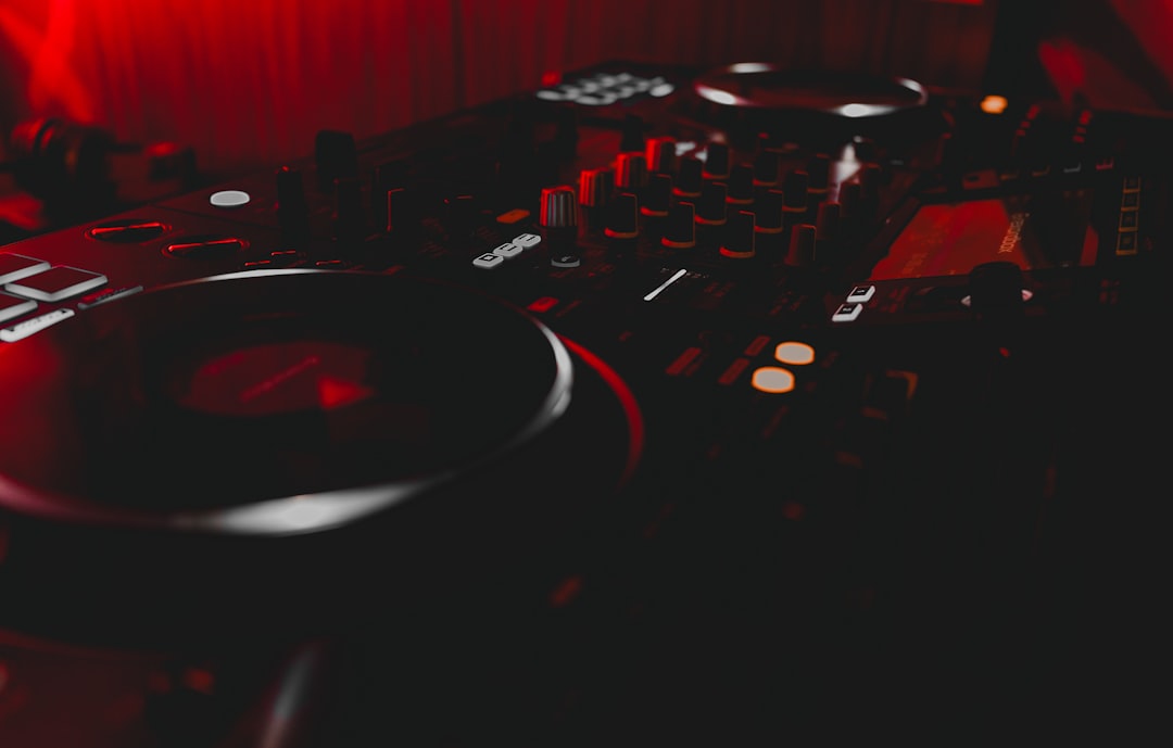 a dj mixing equipment in a dark room,