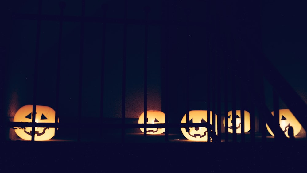 a group of carved pumpkins sitting on top of a window sill