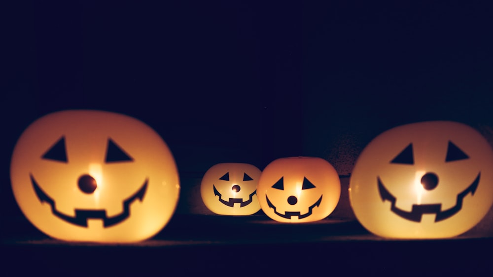 a group of pumpkins with faces carved into them