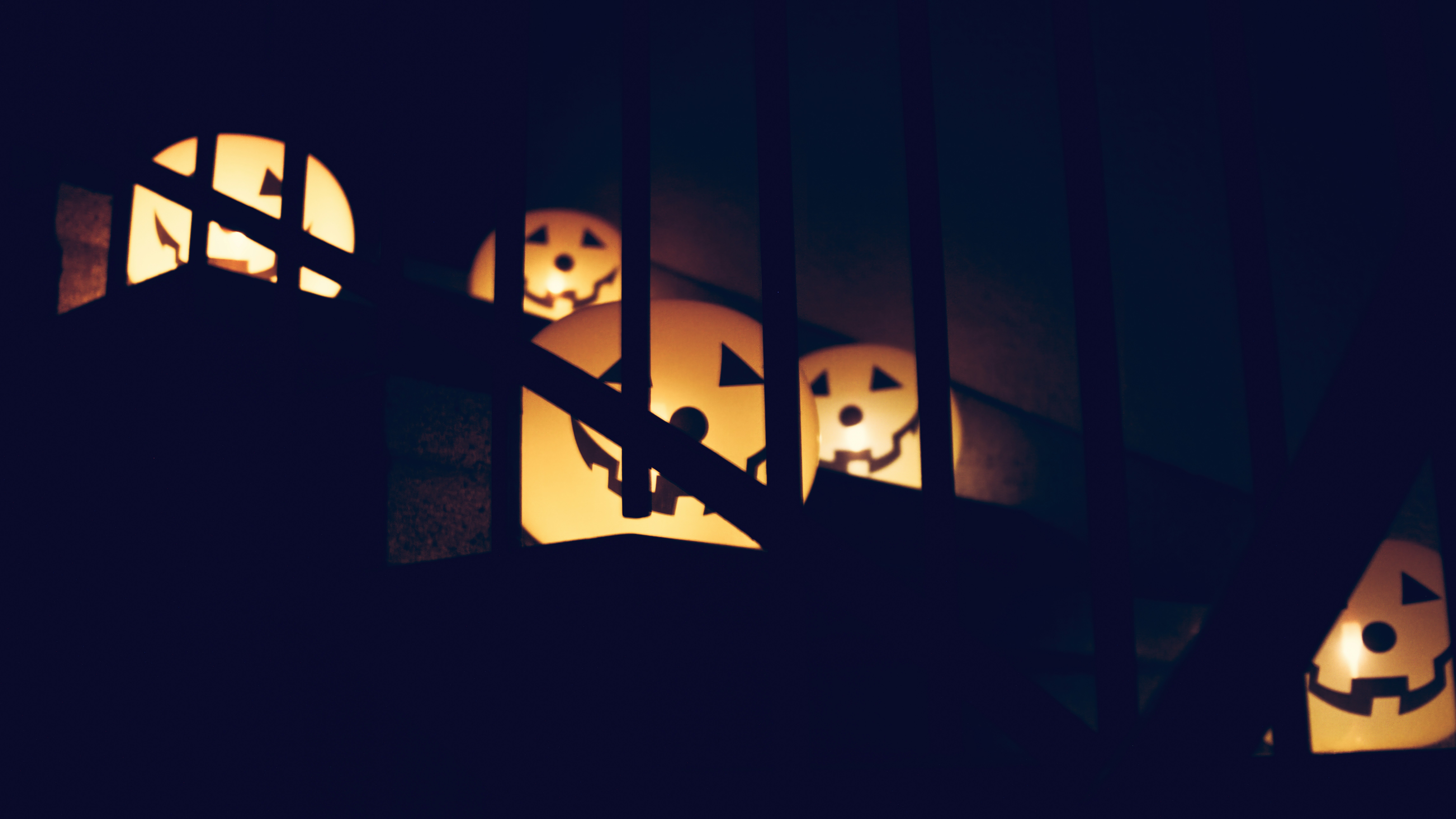 a group of jack o lantern lanterns lit up in the dark