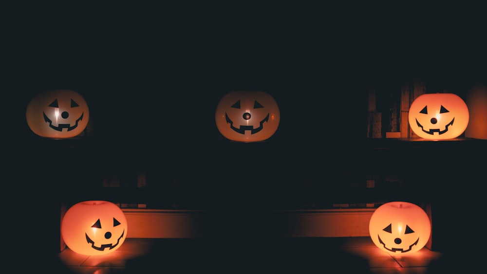 a group of pumpkins with faces carved into them