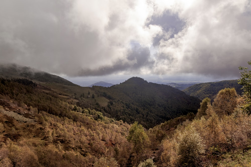 a view of a mountain range with clouds in the sky