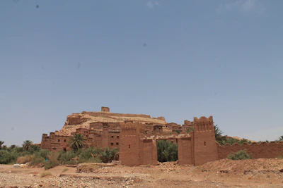 The ancient walls of Ait Ben Haddou Kasbah glowing warmly in the afternoon light.