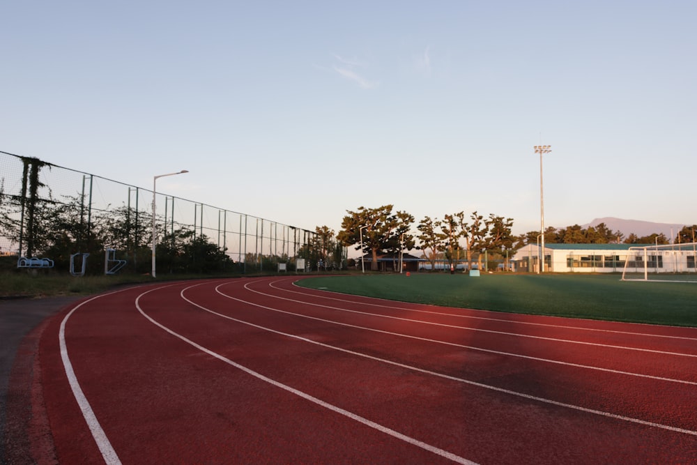 a running track with a fence in the background