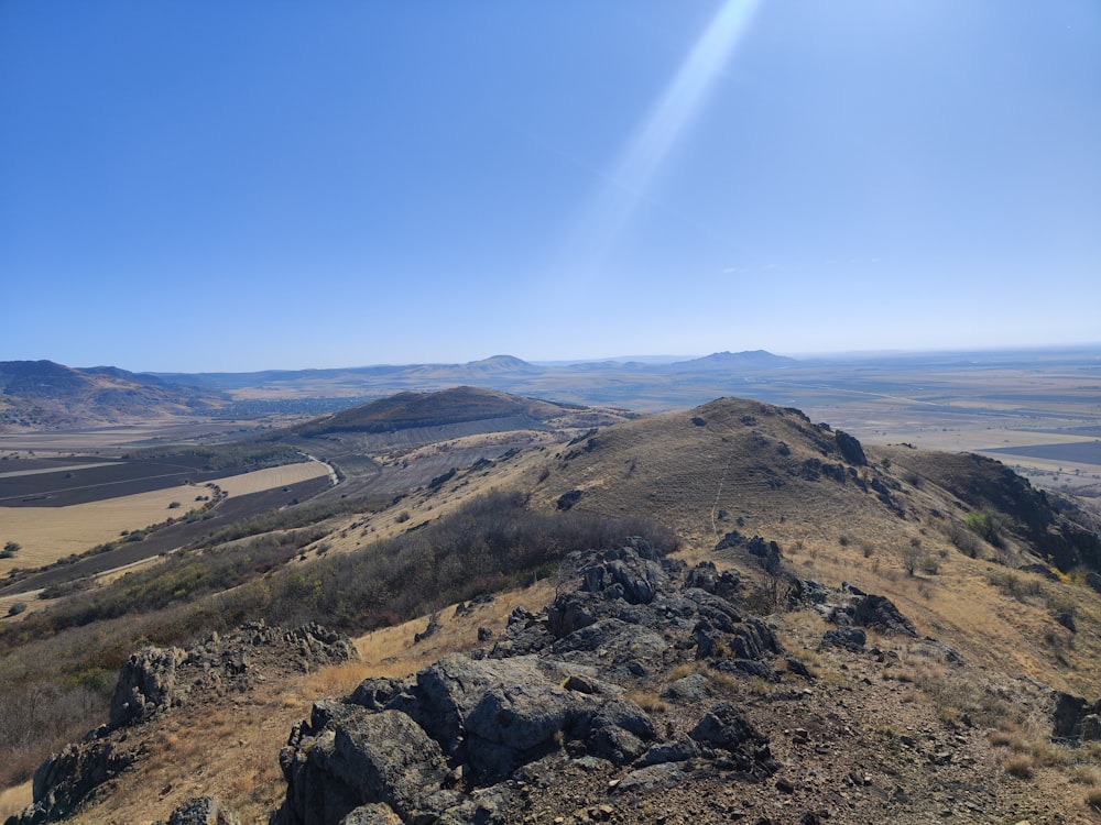 a view of a mountain range from the top of a hill