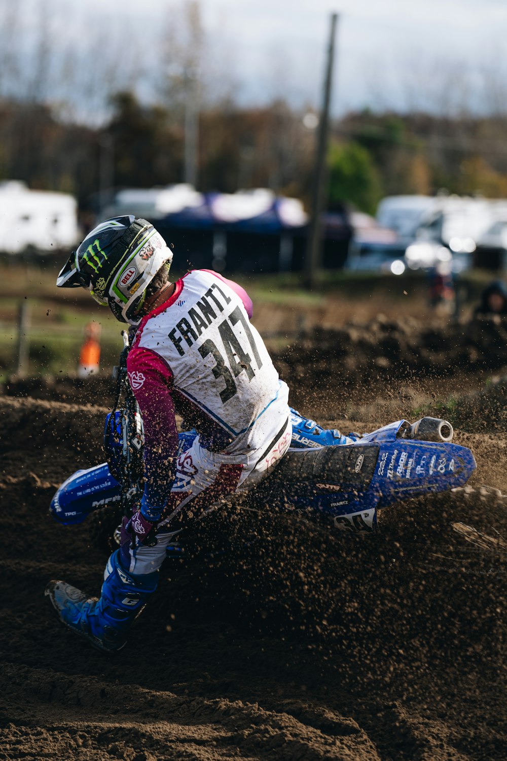 a person riding a dirt bike on a dirt track