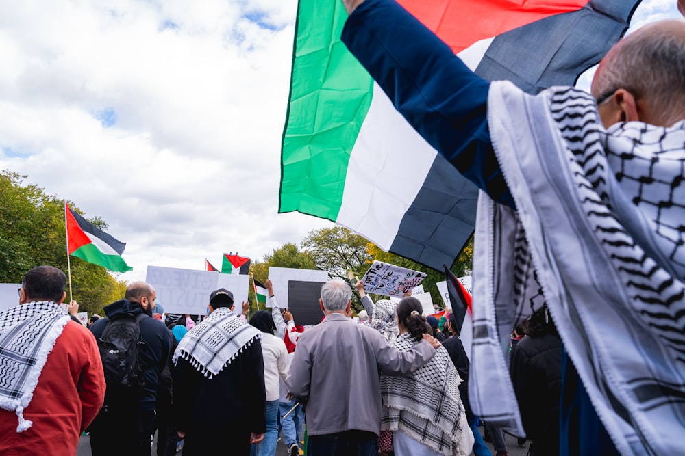 a group of people holding flags and banners