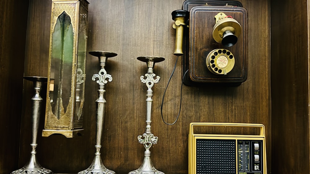 a collection of old fashioned telephones and candles