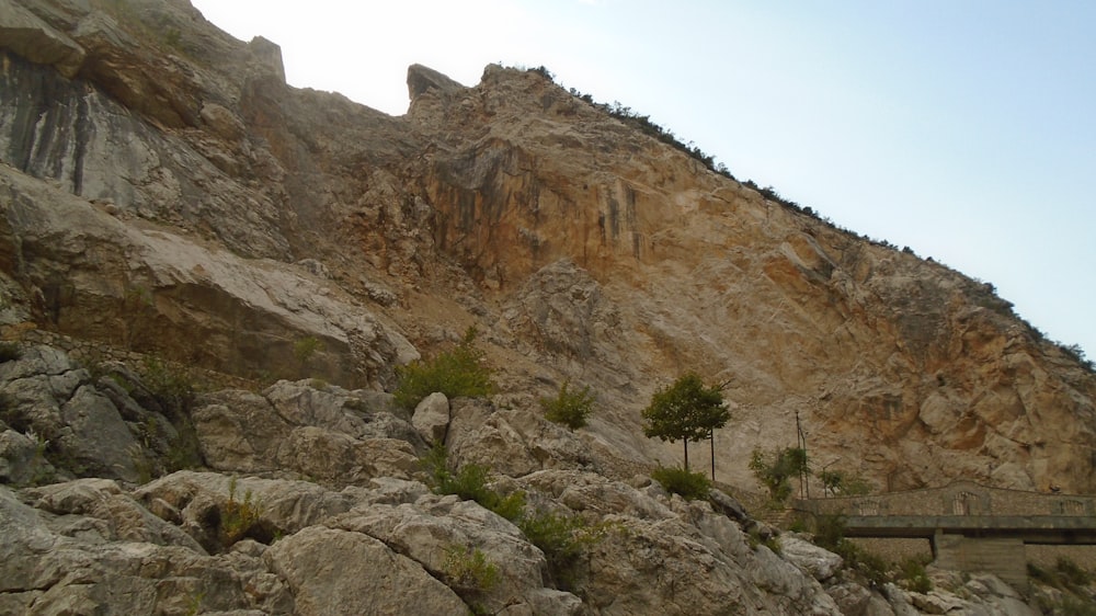 a mountain side with a bridge going over it