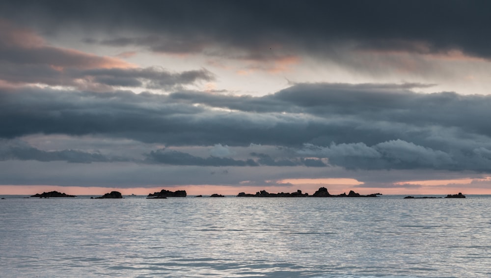 a large body of water under a cloudy sky