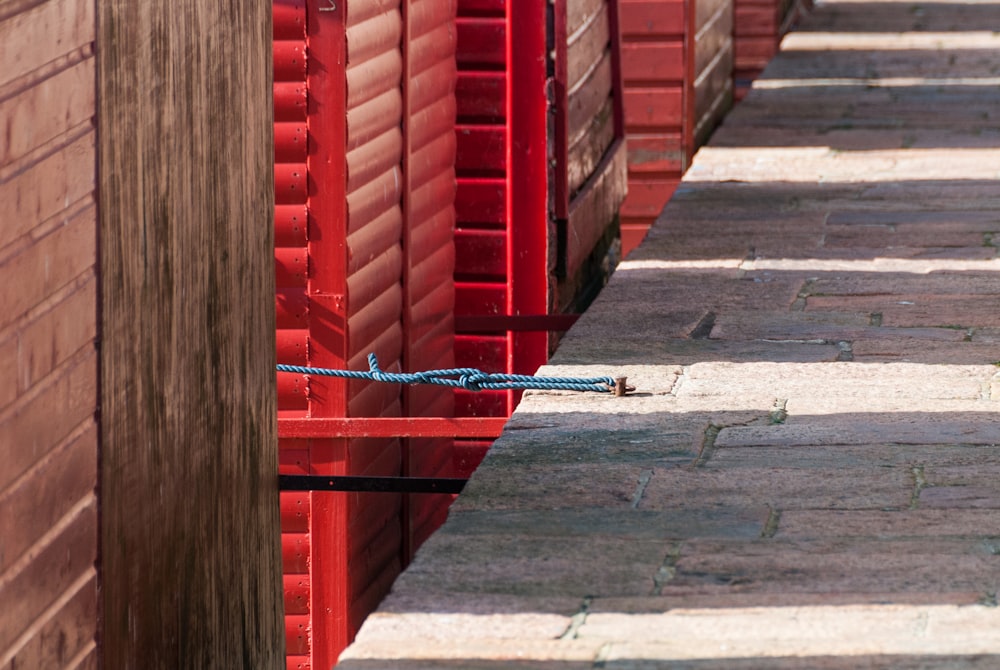 a line of red boxes on the side of a building