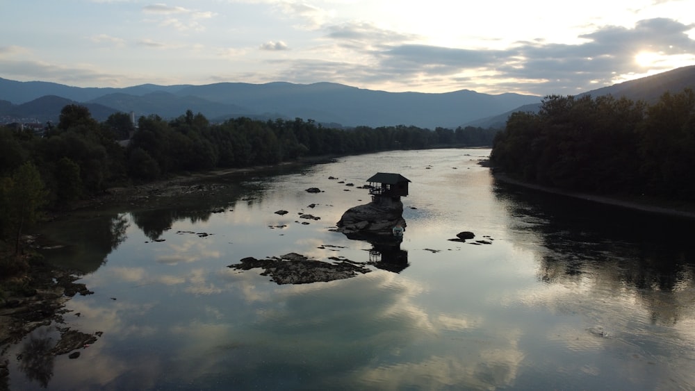 a body of water surrounded by trees and mountains