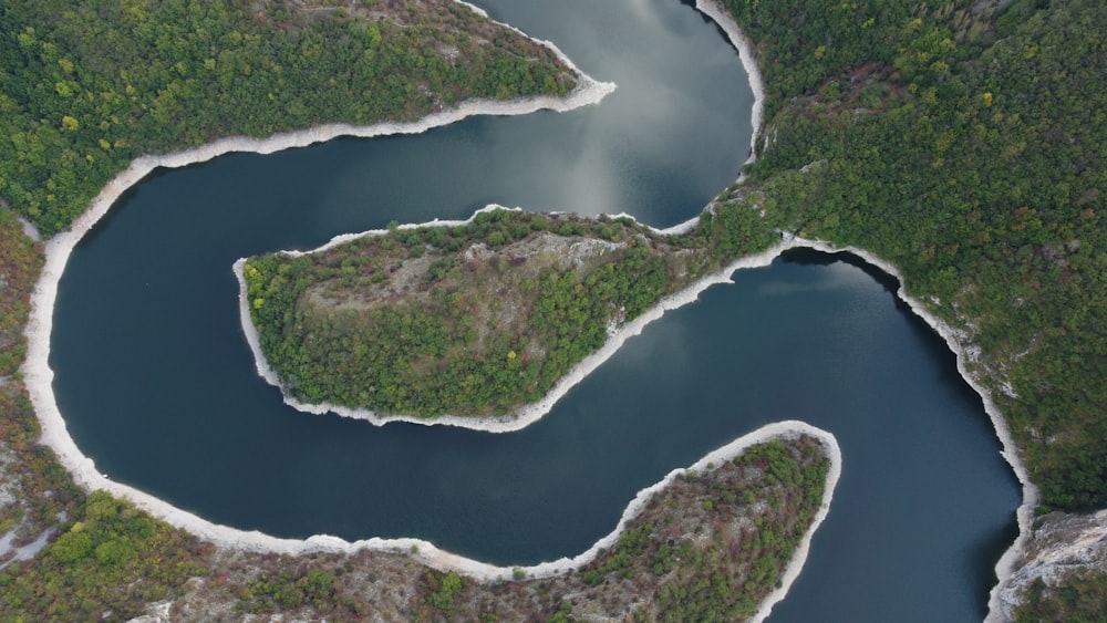 an aerial view of a body of water surrounded by trees