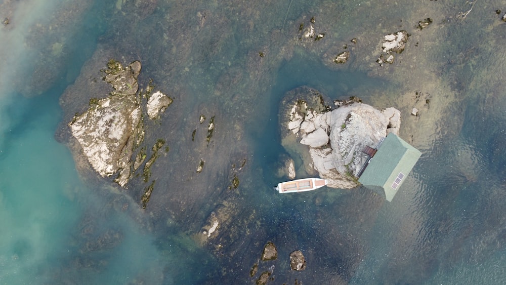 an aerial view of a boat in a body of water