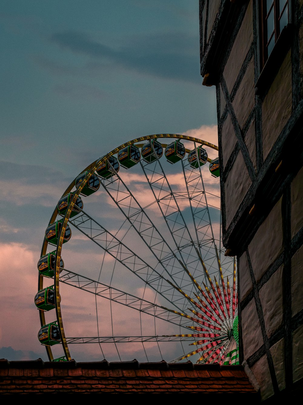 a large ferris wheel sitting next to a tall building