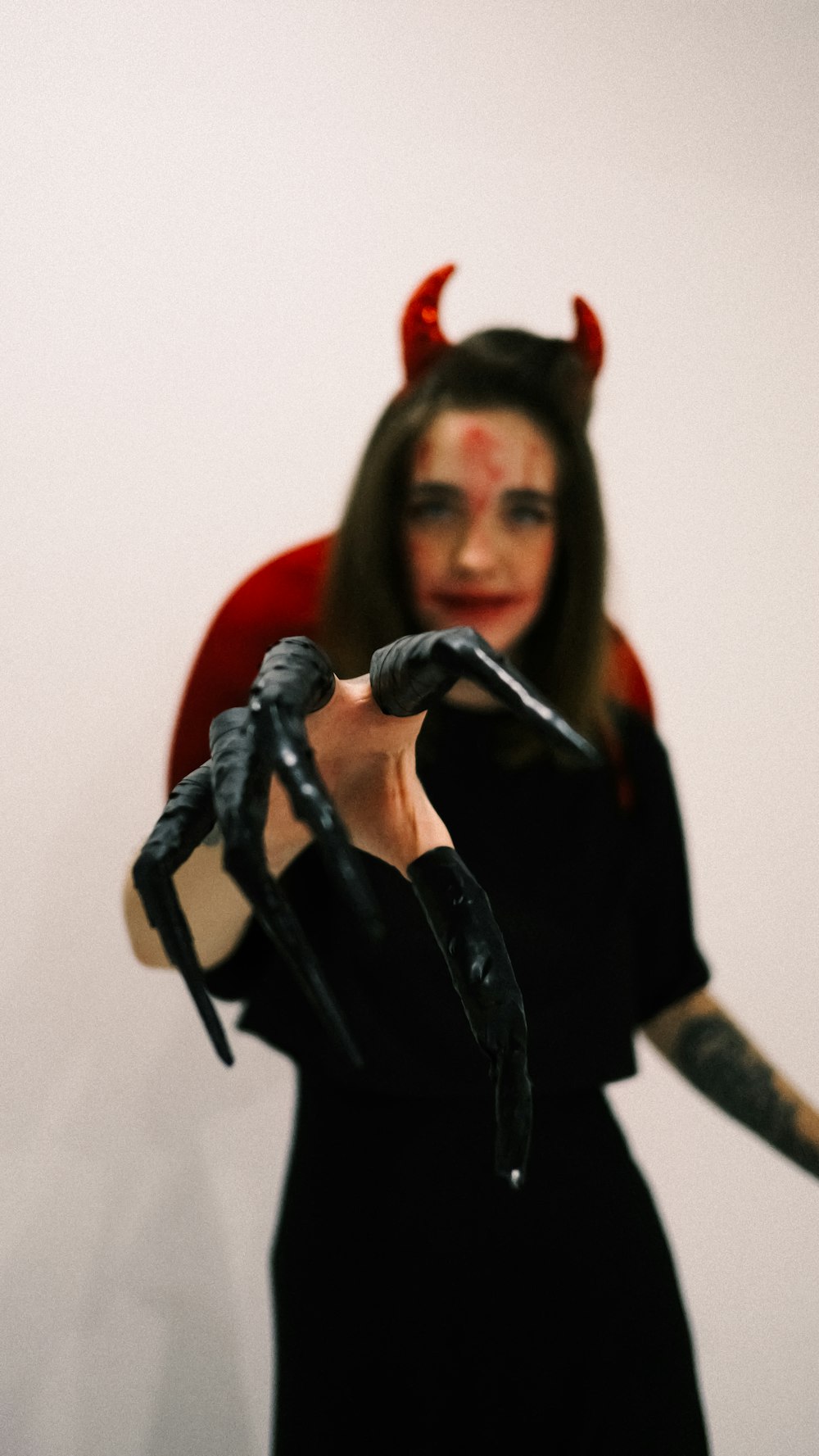 a woman in a devil costume holding a microphone