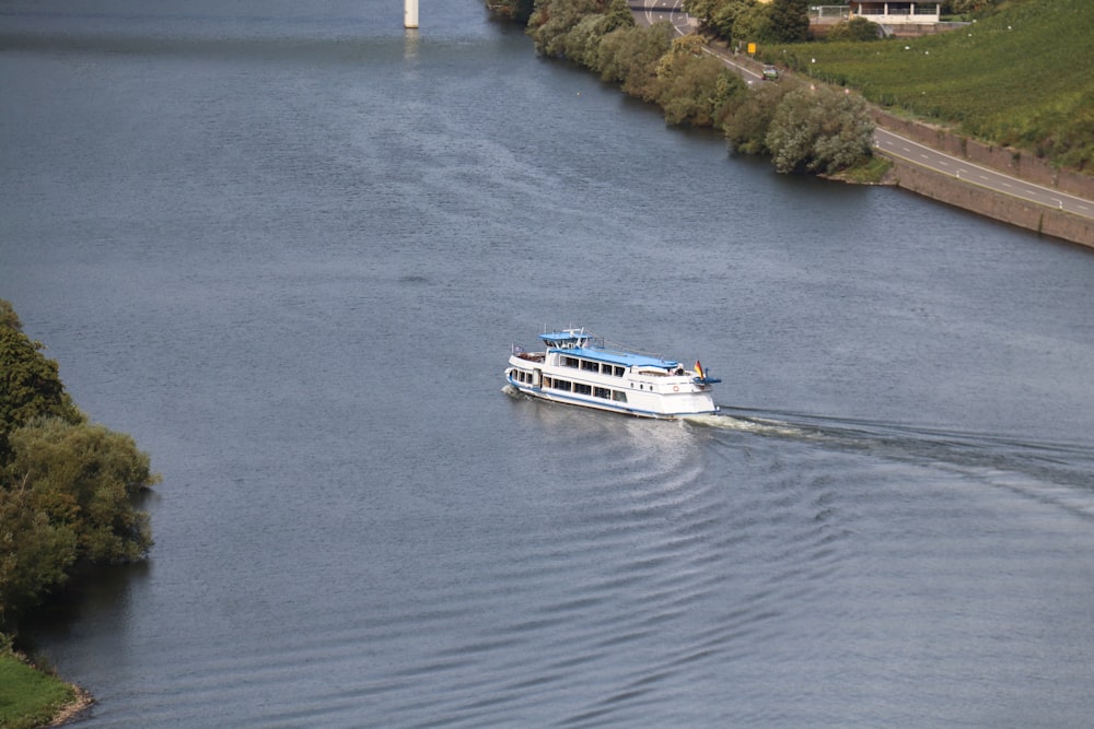 a boat traveling down a river next to a bridge