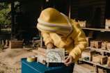 a person in a yellow jacket is painting a picture