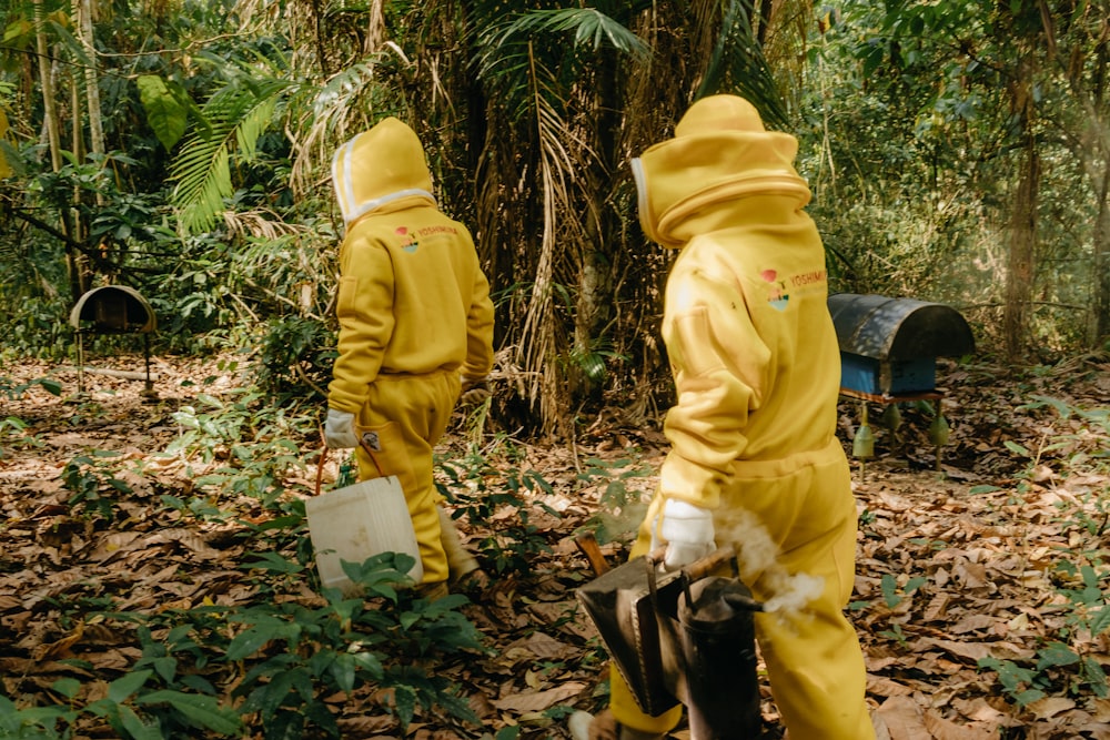 two people in yellow suits in the woods