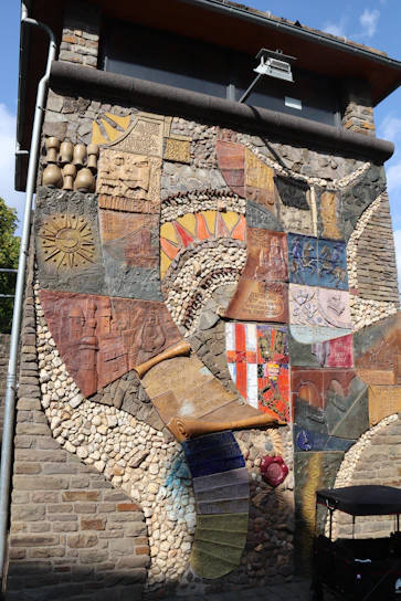 A vibrant mural illustrating Sevilla's historical landmarks, designed by Granao Estudio.