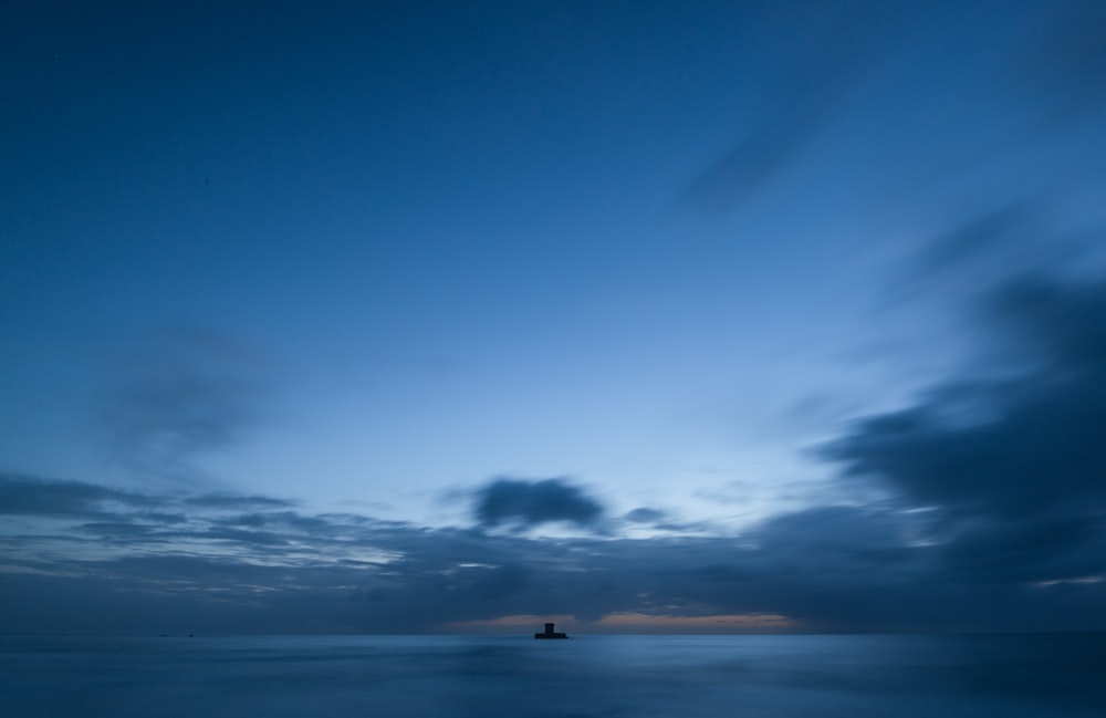 a long exposure photo of a boat in the ocean