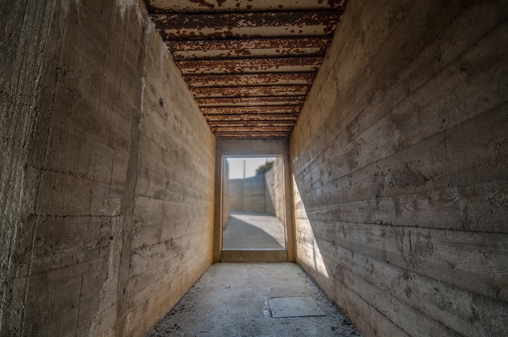 a long narrow hallway with a window in the middle