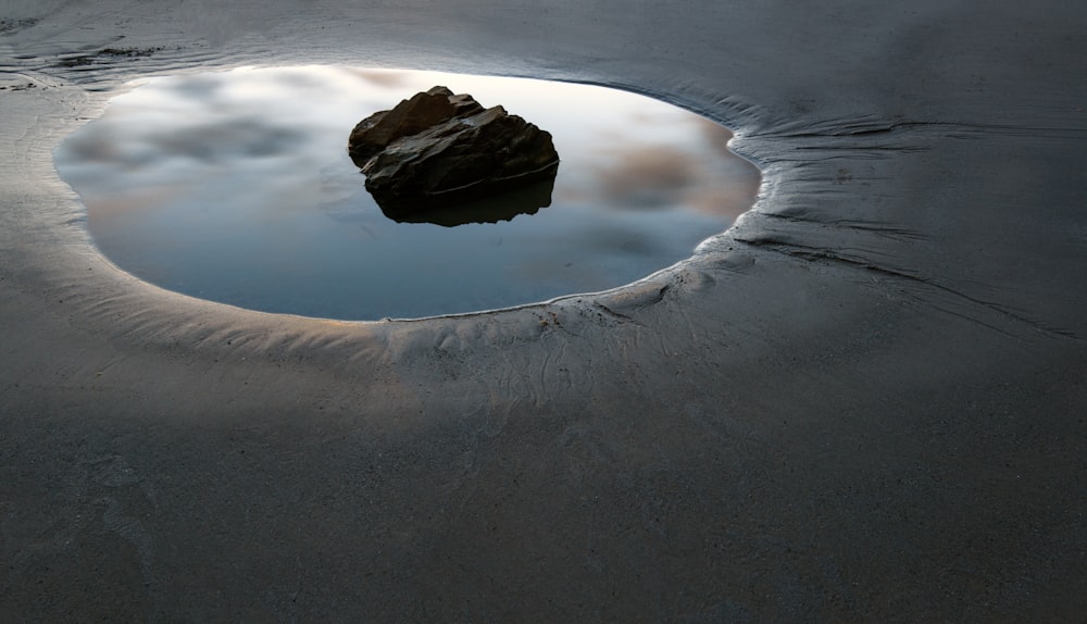 a rock in the middle of a body of water