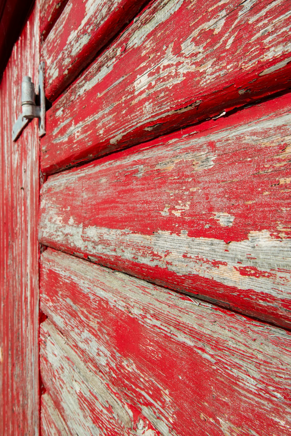 a close up of the side of a red wooden building