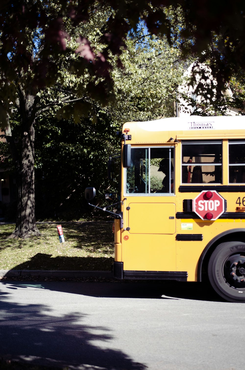 a yellow school bus parked on the side of the road