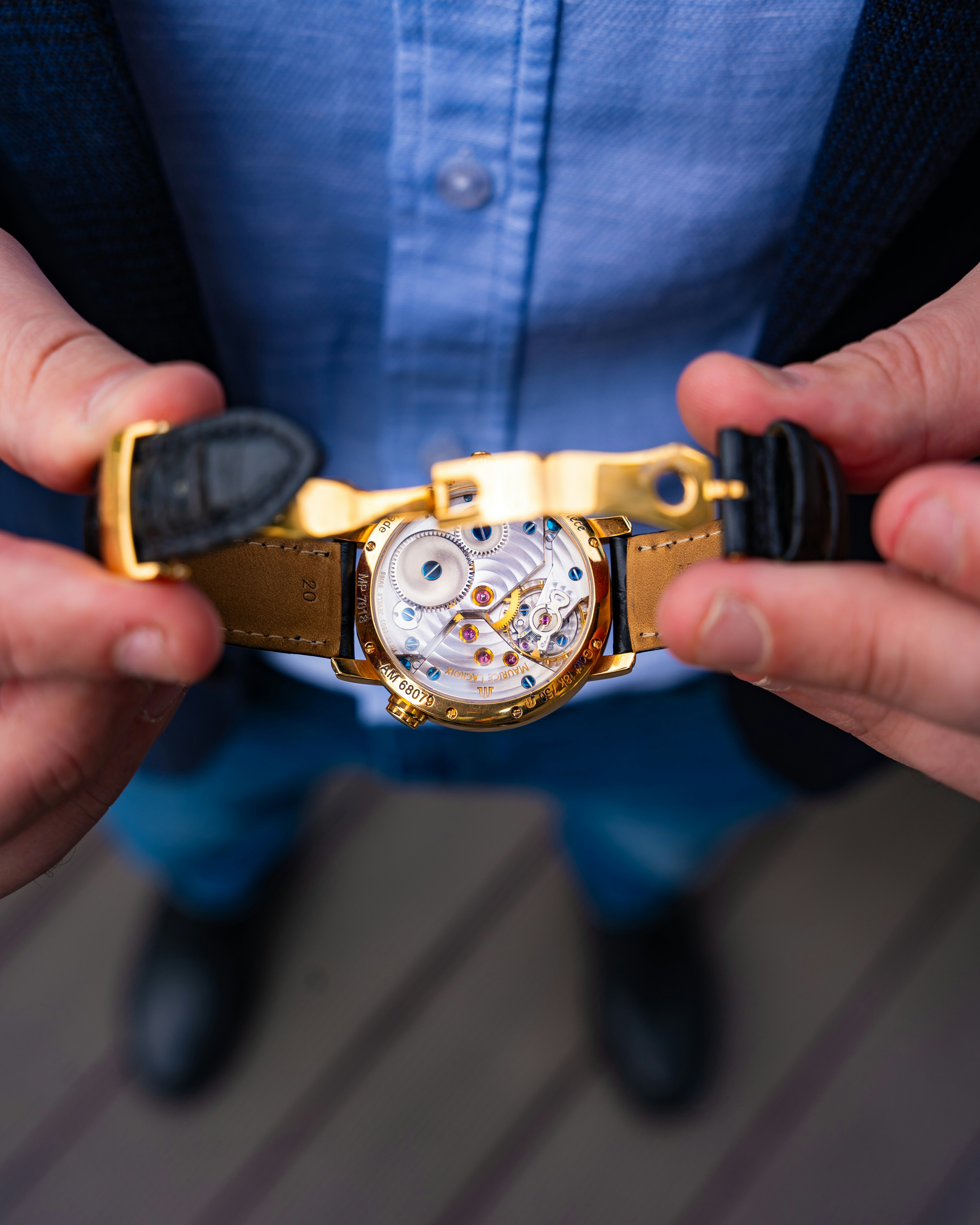 a close up of a person holding a watch