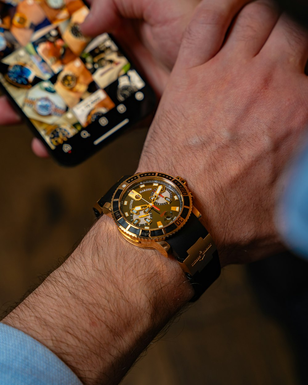 a man holding a smart phone and a watch