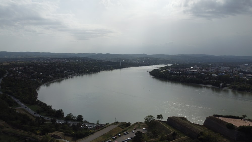 a large body of water with a bridge in the background