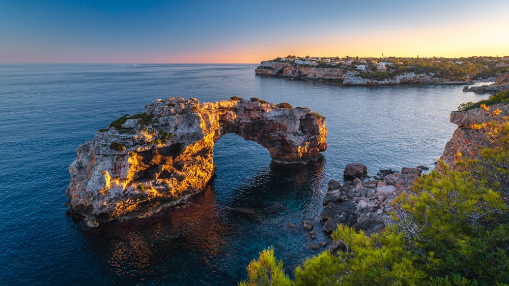 a large body of water near a rocky shore