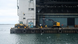 Construction site of a sturdy pier with heavy machinery and workers.