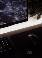 Close-up of hands setting up automated workflows on a computer screen with black and neon green accents.