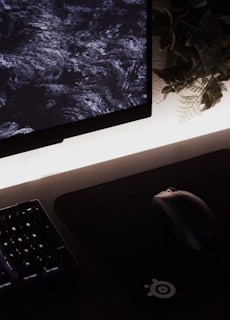 A vibrant sublimated mouse pad featuring a floral pattern on a desk