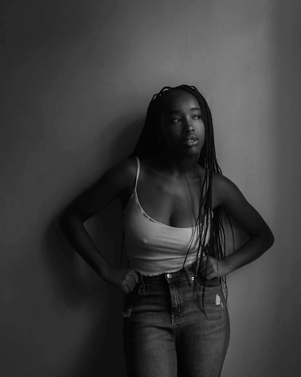 a black and white photo of a woman with dreadlocks