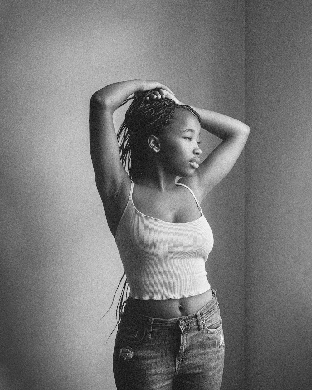 a black and white photo of a woman in a tank top